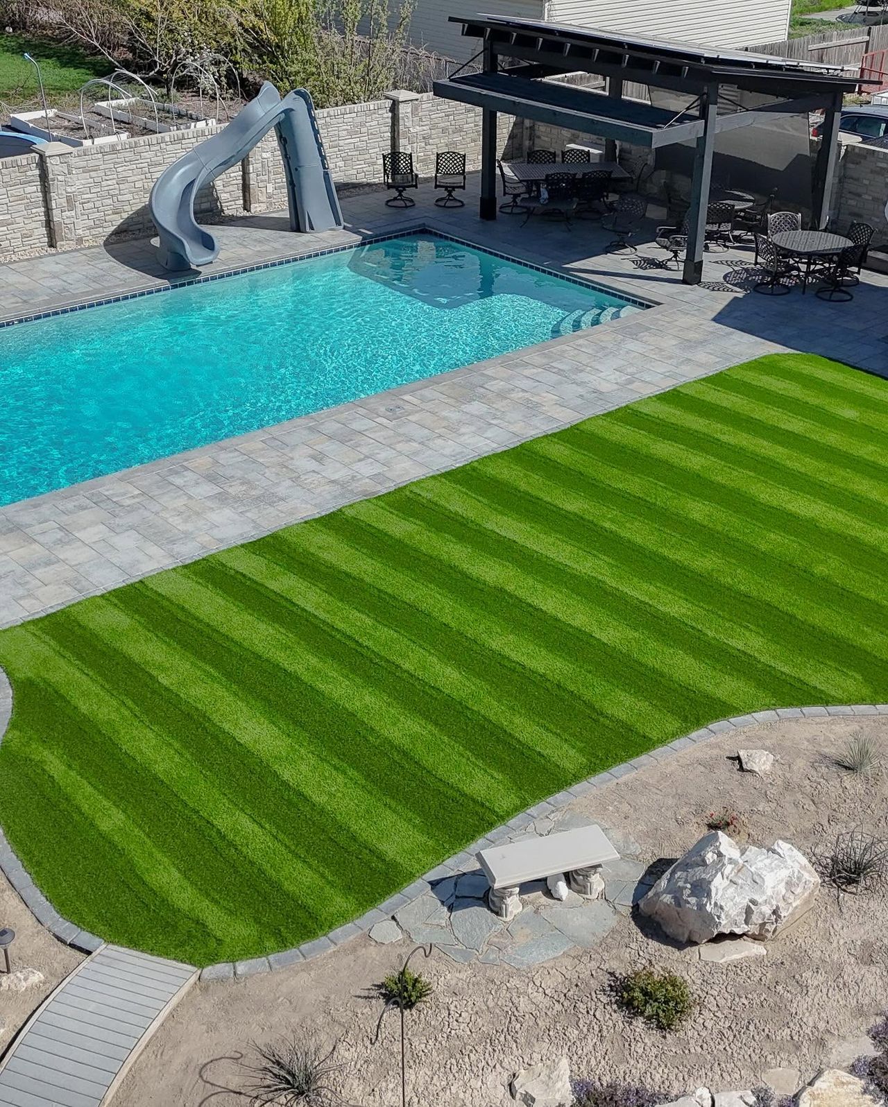 Artificial turf running up to the edge of a pool surround