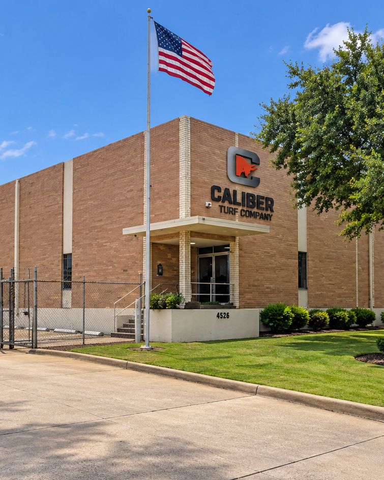 The Caliber Turf Company building at 4526 Bronze Way in Dallas, the company name and logo mounted above the entrance
