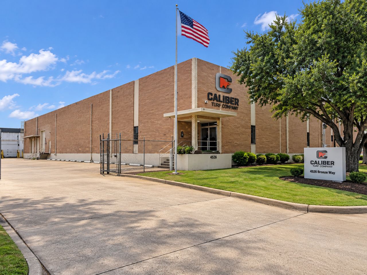 The Caliber Turf Company warehouse at 4526 Bronze Way in Dallas, the company name and logo mounted above the entrance